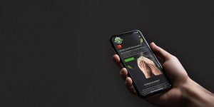 Un smartphone affiche la page d'accueil du site web de l'école de pizzaïolo, mettant en avant les formations proposées et les avantages de devenir pizzaïolo.